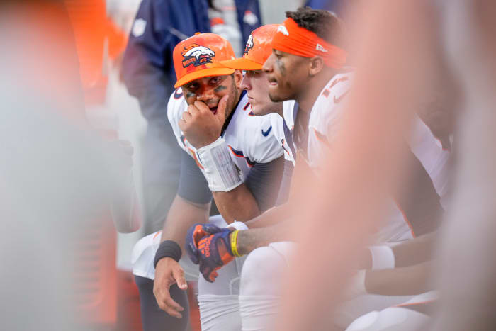 Russell Wilson sitting on the Broncos bench